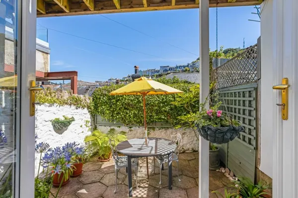 Private courtyard with parasol and garden furniture