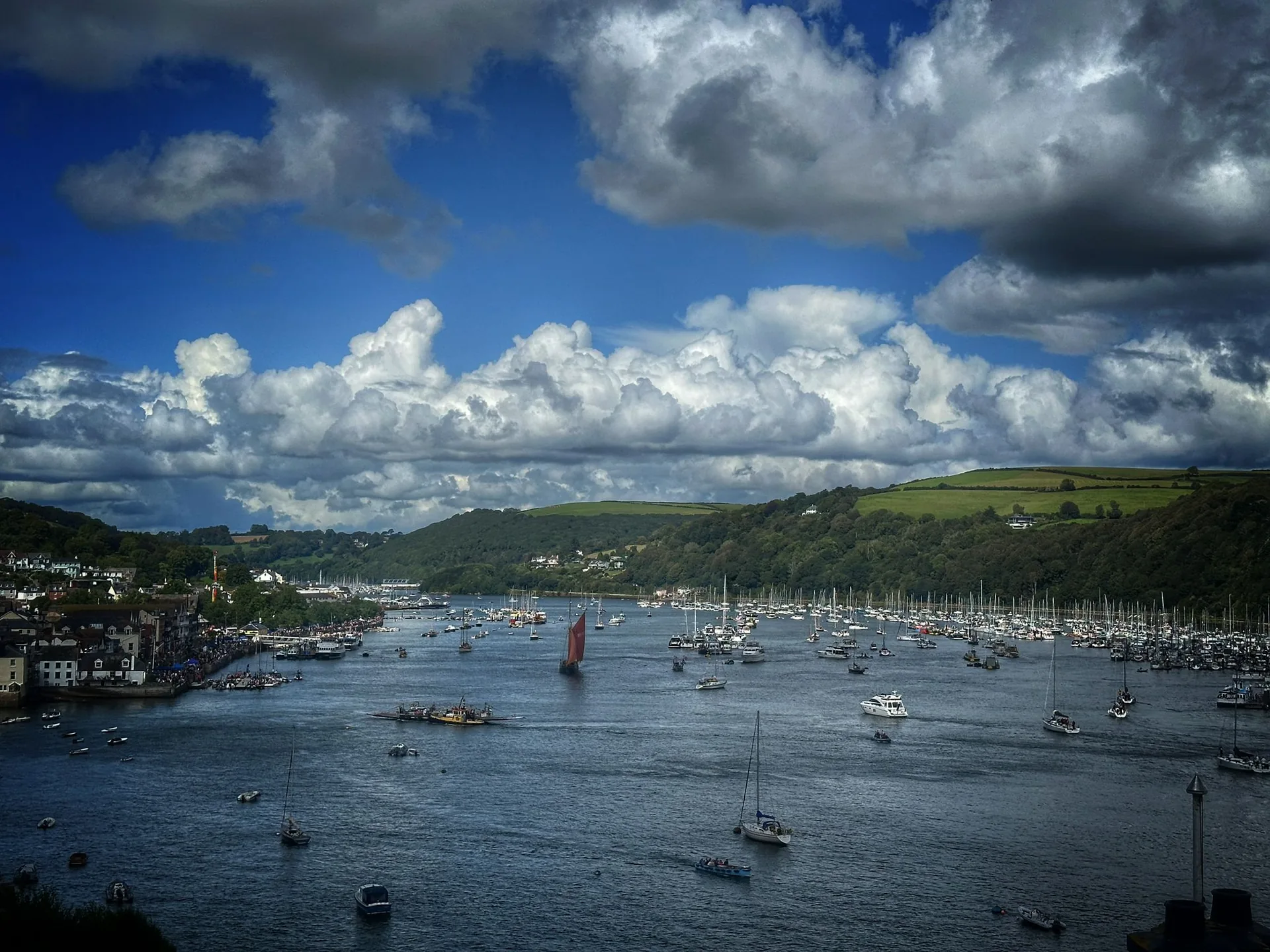 River Dart packed with sailing boats under dramatic clouds