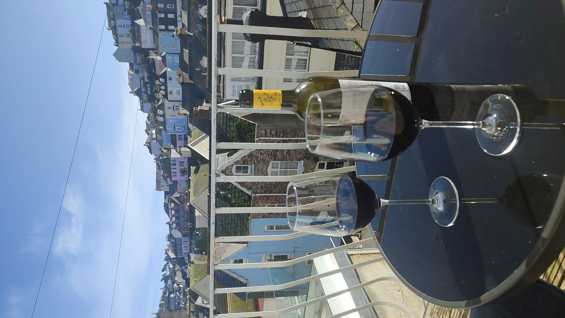 Wine glasses on the balcony with Dartmouth rooftop views