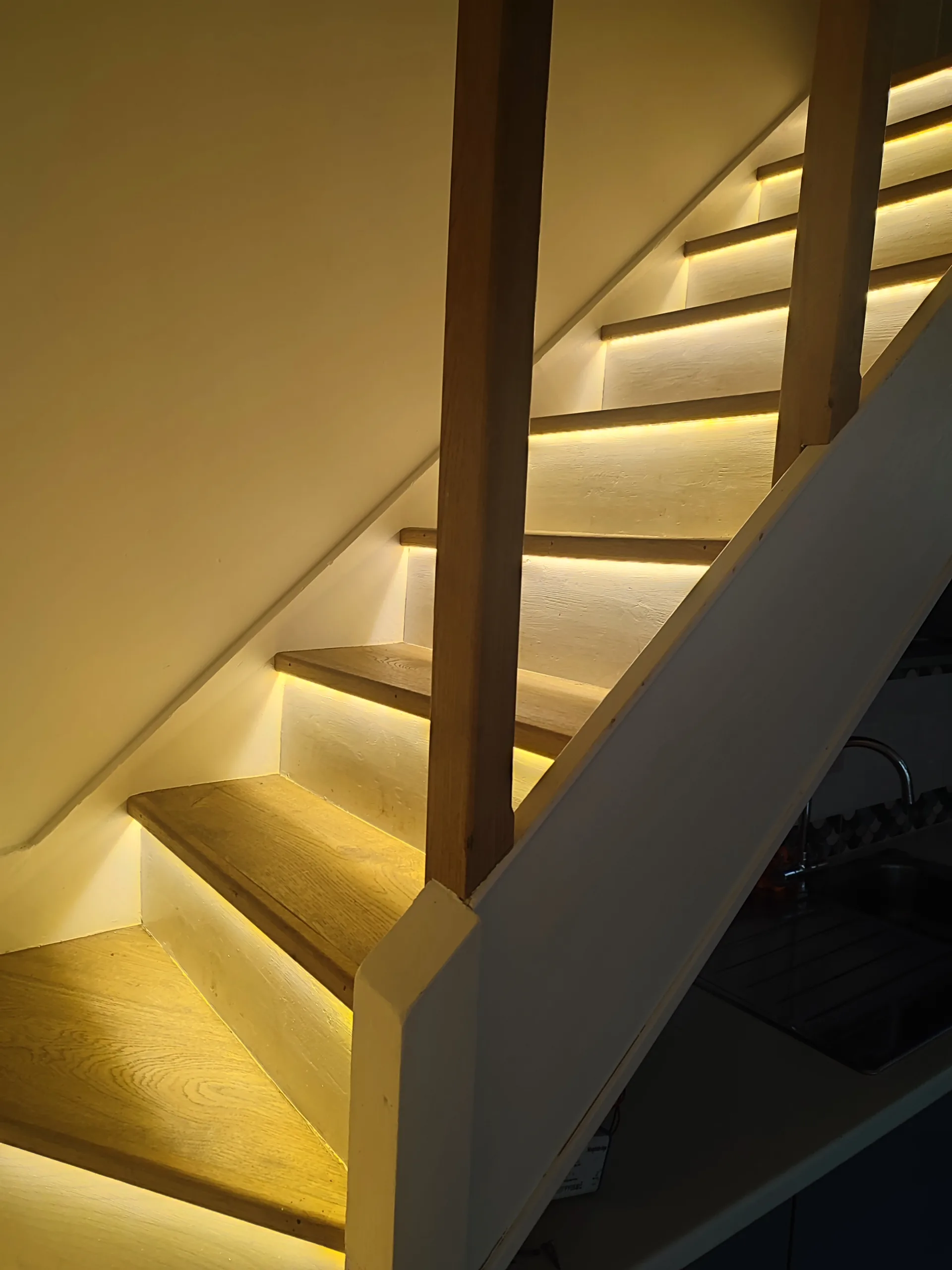 Oak staircase with warm LED strip lighting